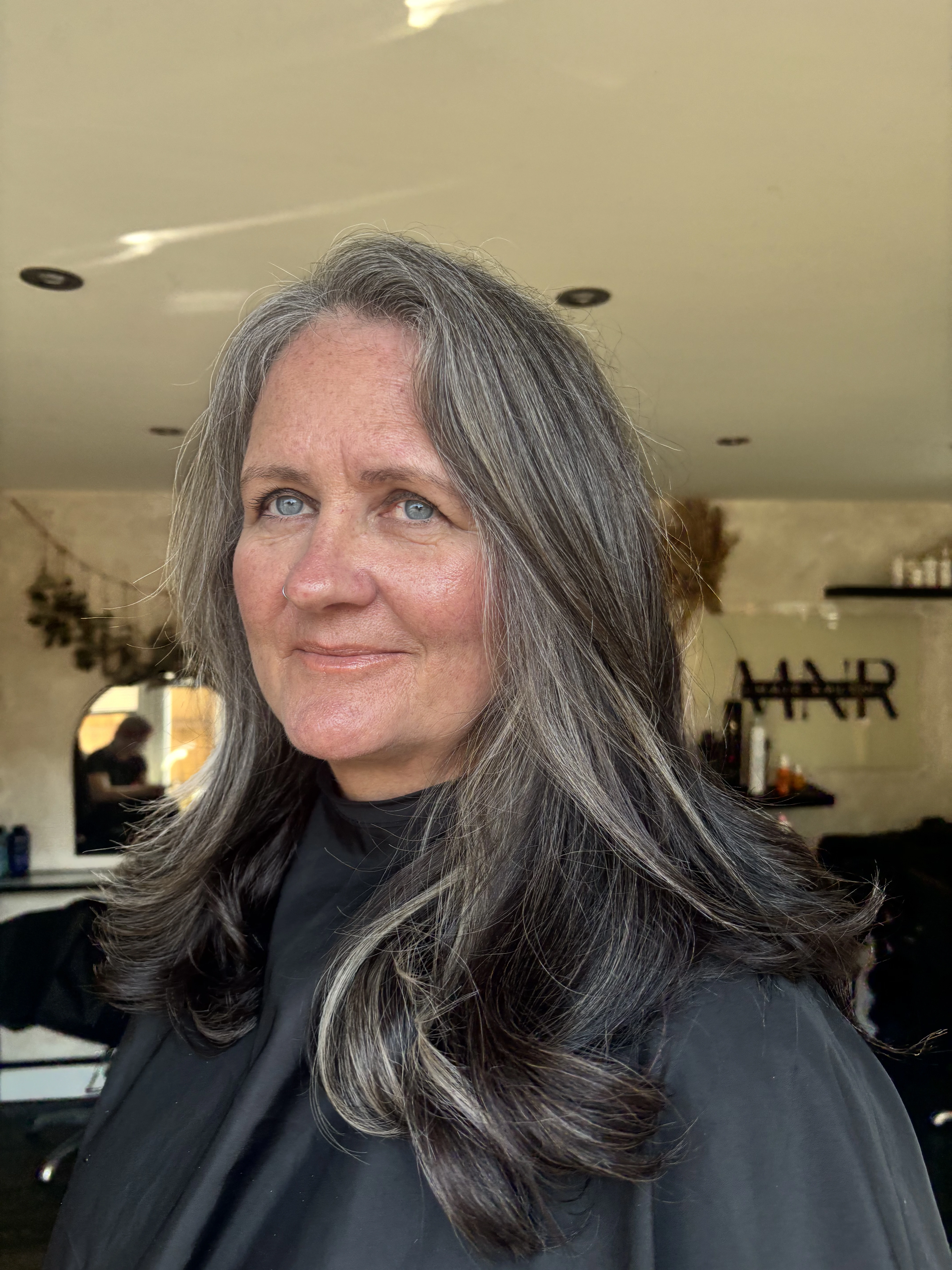 Long dimensional grey blending result on a client at MNR Hair
