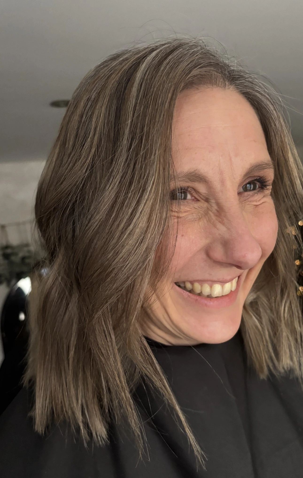 Smiling client with a soft natural grey blending result