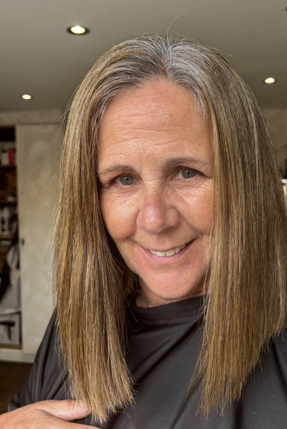 Before grey blending with brunette lengths and visible natural silver regrowth